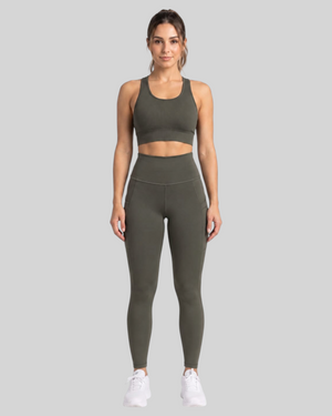 Olive brown high-waisted leggings with front pockets from Proven Sportswear, shown on a model against a neutral background.