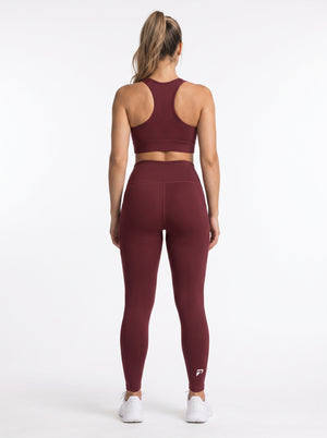 Maroon high-waisted pocket leggings by Proven Sportswear, featuring a comfortable fit and functional side pockets.