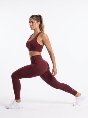 Maroon high-waisted pocket leggings by Proven Sportswear, showing the full length of the fitted athletic leggings with side pockets.