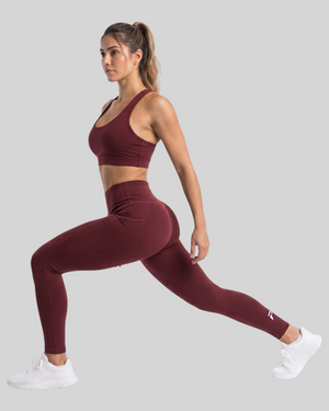 Maroon high-waisted pocket leggings by Proven Sportswear, showing the full length of the fitted athletic leggings with side pockets.