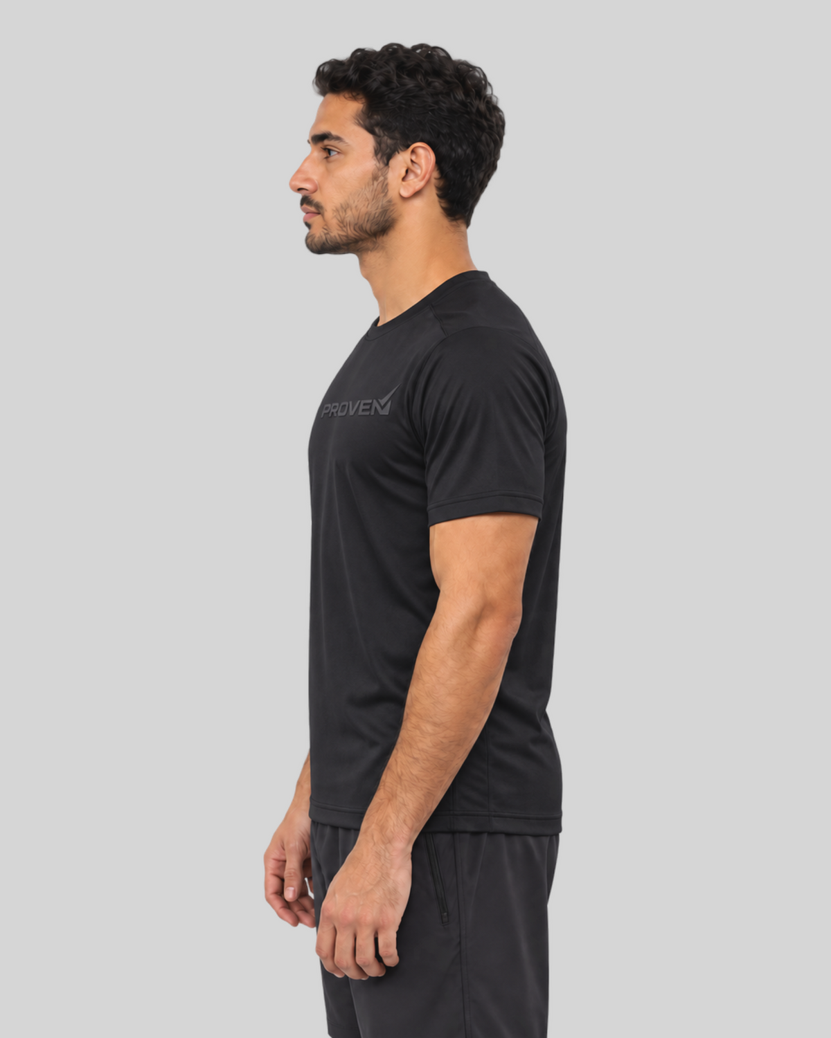 Black Proven Sportswear Performance Tee, a fitted sports T-shirt with breathable fabric and athletic design, shown on a model.