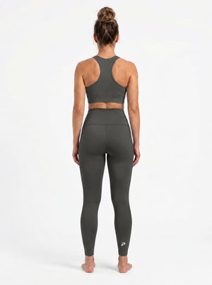 High-waisted olive brown pocket leggings by Proven Sportswear, showing the stretchy fabric and functional pockets.