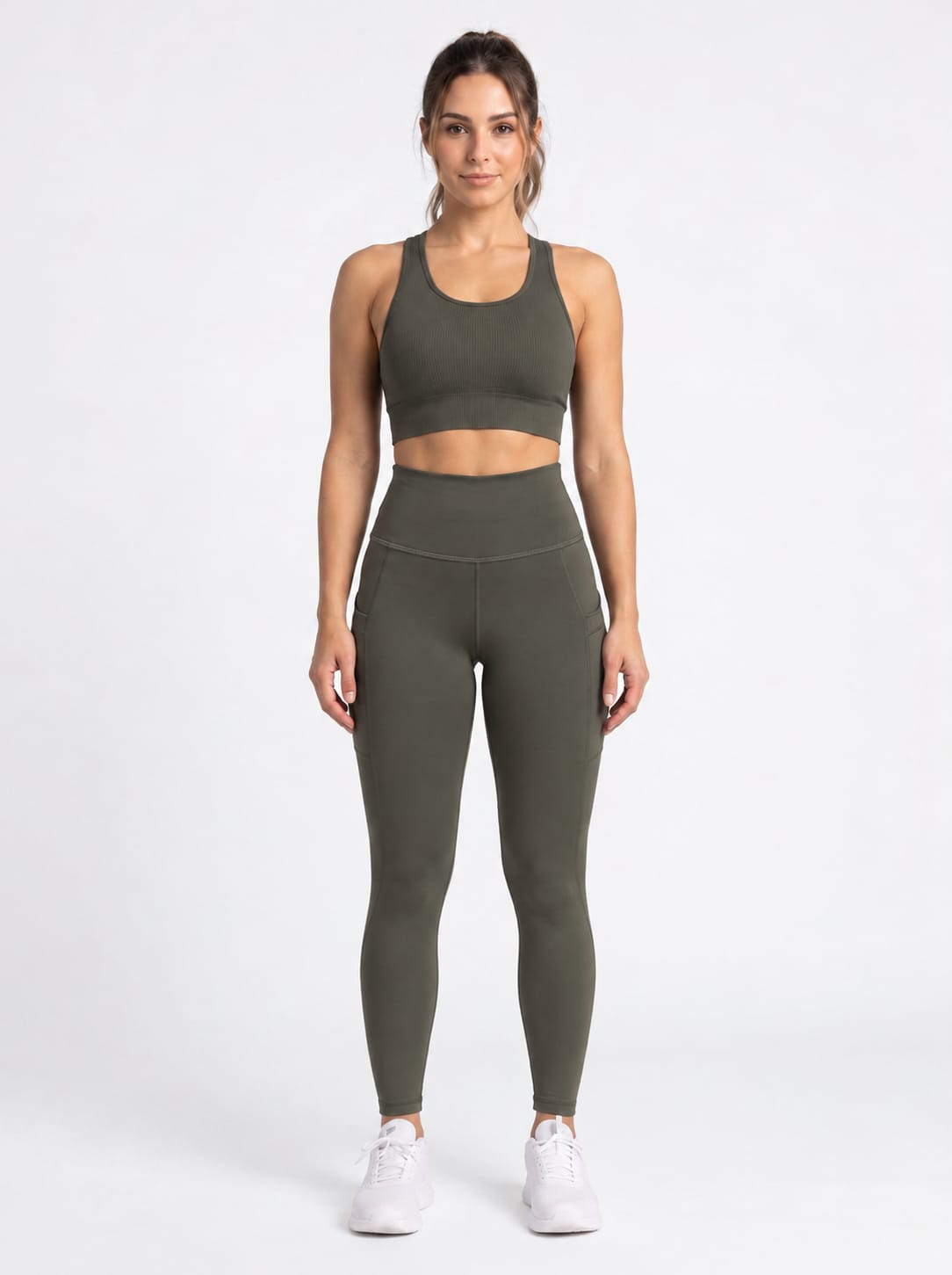 Olive brown high-waisted leggings with front pockets from Proven Sportswear, shown on a model against a neutral background.
