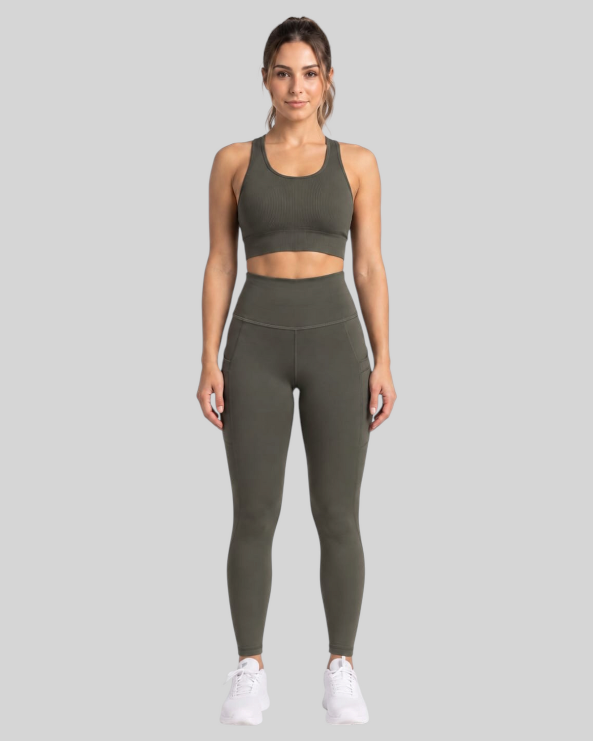 Olive brown high-waisted leggings with front pockets from Proven Sportswear, shown on a model against a neutral background.