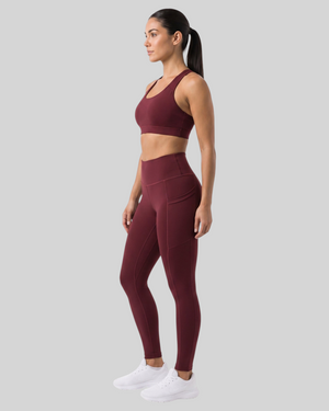 Maroon high-waisted pocket leggings by Proven Sportswear, showing a close-up of the textured fabric and pocket details.