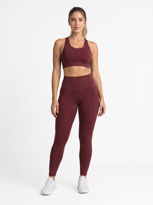Maroon high-waisted pocket leggings by Proven Sportswear, showing a close-up of the comfortable, stretchy fabric and functional pockets.